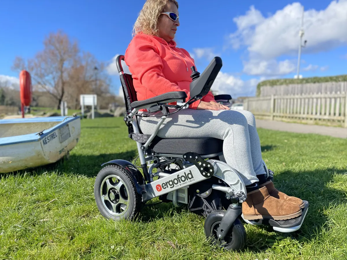 ErgoFold Elite rider enjoying a sunny day beside a boat